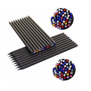 Close-up of black wooden pencils with colorful rhinestone ends and sharpened tips