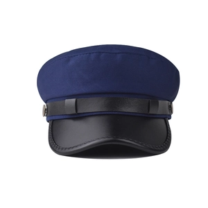 Detail of navy baker boy hat featuring textured fabric and black faux leather brim