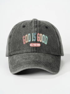 Detailed macro view of the GOD IS GOOD ALL THE TIME printed text on dark grey baseball cap