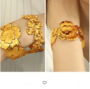 Detail of luxury gold camellia floral cuff bracelet showing intricate petal textures