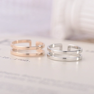 Macro shot of minimalist adjustable double-layer rings in rose gold and silver finish