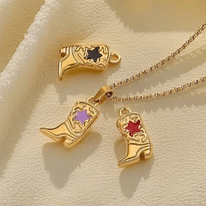 Gold cowboy boot necklace and charms with colorful star inlays on woven fabric