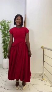 Detalle de un vestido largo rojo oscuro de cintura alta con mangas cortas y dos bolsillos