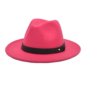 Detail of rose pink wool fedora featuring a black leather band and gold metal rivet