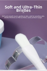 Macro shot showing 4mm thick soft bristles of the facial mask brush on a purple background