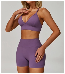 Detail of purple seamless yoga set showing double strap sports bra and high waist shorts