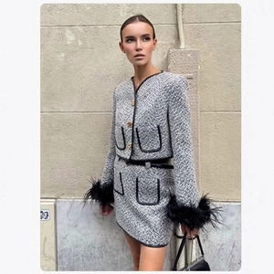 Elegant grey tweed two-piece set with black feather trim and gold buttons for women