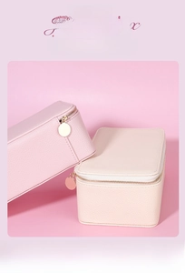 Detail of smooth metal zipper on luxury travel jewelry box with multiple compartments