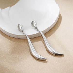 Detailed view of long silver teardrop earrings with polished finish and minimalist design