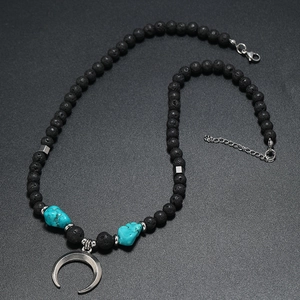 Detail view of Bohemian lava stone beads with turquoise and silver crescent moon pendant