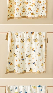 Detailed view of 6-layer cotton gauze baby towels with lion and dinosaur prints