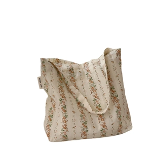 Floral cotton shoulder bag with orange flower patterns and simple wish woven label