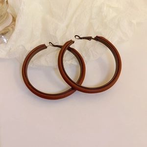 Vintage brown leather hoop earrings with silver pins and dark metal frame for women