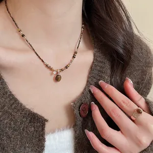 Vintage gold plated tiger eye jewelry set including necklace and ring on model