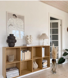 Minimalist wooden storage shelf with 8 square compartments in a cozy living room