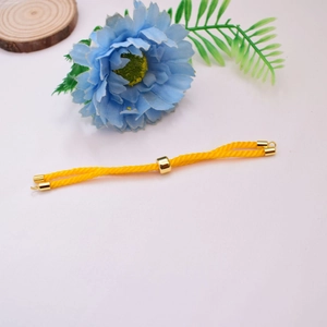 Detail of yellow Milan cord bracelet with 18K gold-plated sliding bead and adjustable clasp