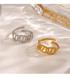 Detail view of gold and silver stainless steel rings on a ripple water background