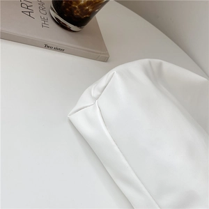 Stylish large white faux leather tote bag on desk with book and coffee cup accessory