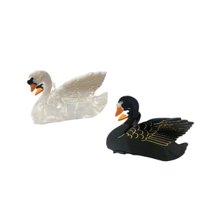 Elegant swan acetate hair clips set in black and white with golden feather details