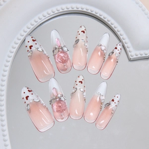 Pink French heart press-on nails with 3D gems and rhinestones in stiletto shape