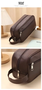 Detail view of large brown PU leather wash bag with double zippers and side handle