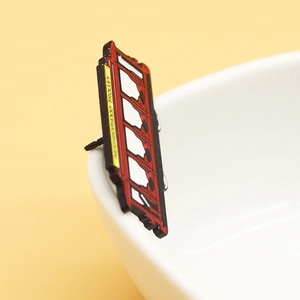 Classic red enamel trolley pin with Neighborhood Trolley text on a white porcelain cup