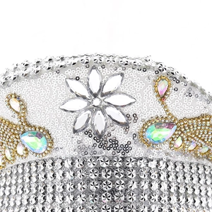 Macro detail of silver sequins, crystal flower, and AB rhinestones on luxury navy hat