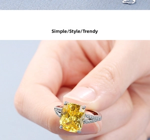 Close-up of cushion-cut yellow gemstone ring with pavé side stones on silver band