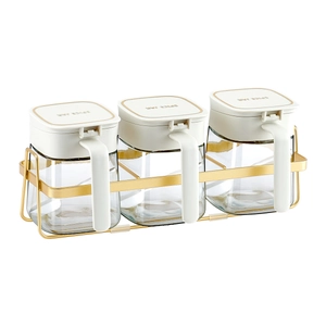 3-piece glass spice jar set with golden metal storage rack and lids for kitchen