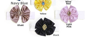 Detail of colorful satin bow headbands with crystal rhinestones on nylon bands