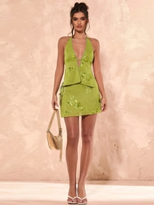 Green two-piece summer set featuring backless halter top and floral embroidered mini skirt