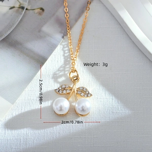 Sweet cherry pendant necklace with double white pearls and rhinestone leaves in gold finish