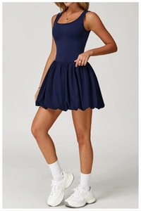 Detail view of navy blue sleeveless sports dress with U-neck and pleated hem design