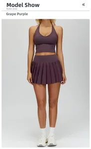 Detail of grape purple high-waisted pleated tennis skirt and matching halter sports top