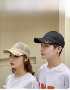 Detail of breathable mesh baseball cap with side red label and embroidery for outdoor use