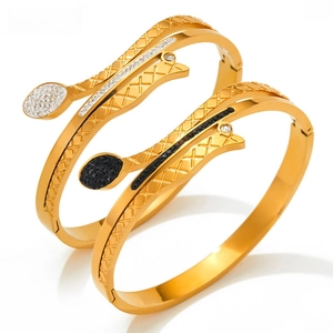 Detail of gold snake bracelets with micro-inlaid stones and intricate mesh engraving