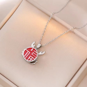 Detailed macro view of silver titanium necklace with red floral pendant and Fu character