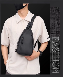 Detail of durable black outdoor chest bag with metal zippers and sturdy buckles