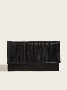 Detail of elegant black clutch bag with vertical pleated texture and glossy finish