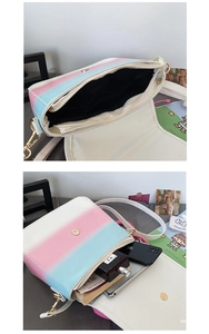 Detail of gradient crossbody bag with gold hardware and white strap in lifestyle setting