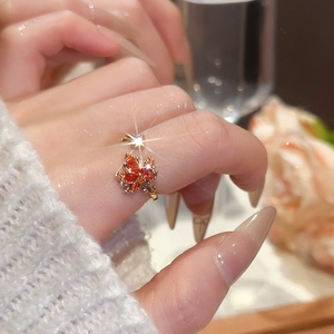 Detail of 18k gold maple leaf ring with orange marquise zircons and white stone