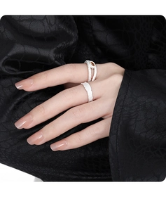 S925 sterling silver hollow rings with brown gemstone inlay on black silk background