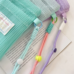 Detail of colorful mesh storage pouches with adjustable braided lanyards and toggles