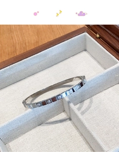 Macro detail of silver square geometric titanium steel bracelet with cubic zirconia