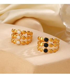 Detail of 18K gold-plated triple-layered openwork rings with black and white inlay