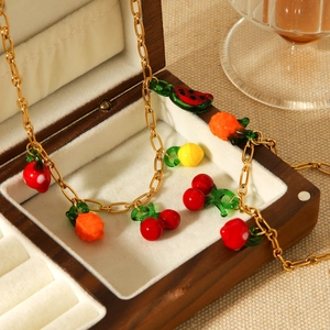Gold stainless steel necklace featuring colorful fruit charms like watermelon and cherry