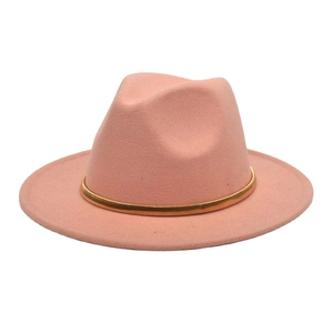 Detail of wide brim pink wool fedora featuring a decorative textured gold metal band