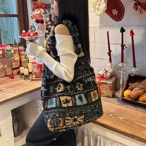 Detailed side view of large plush tote bag with vintage patterns in a festive setting