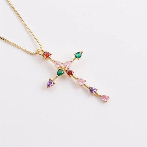 Detailed macro view of gold cross pendant featuring vibrant pear-cut colorful zircons