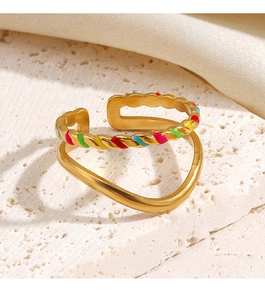 Macro detail of gold double-layer ring with colorful enamel drip on a stone base